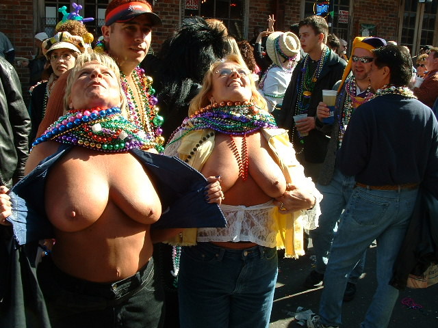 Drunk girls show boobs at mardis gras #76403276