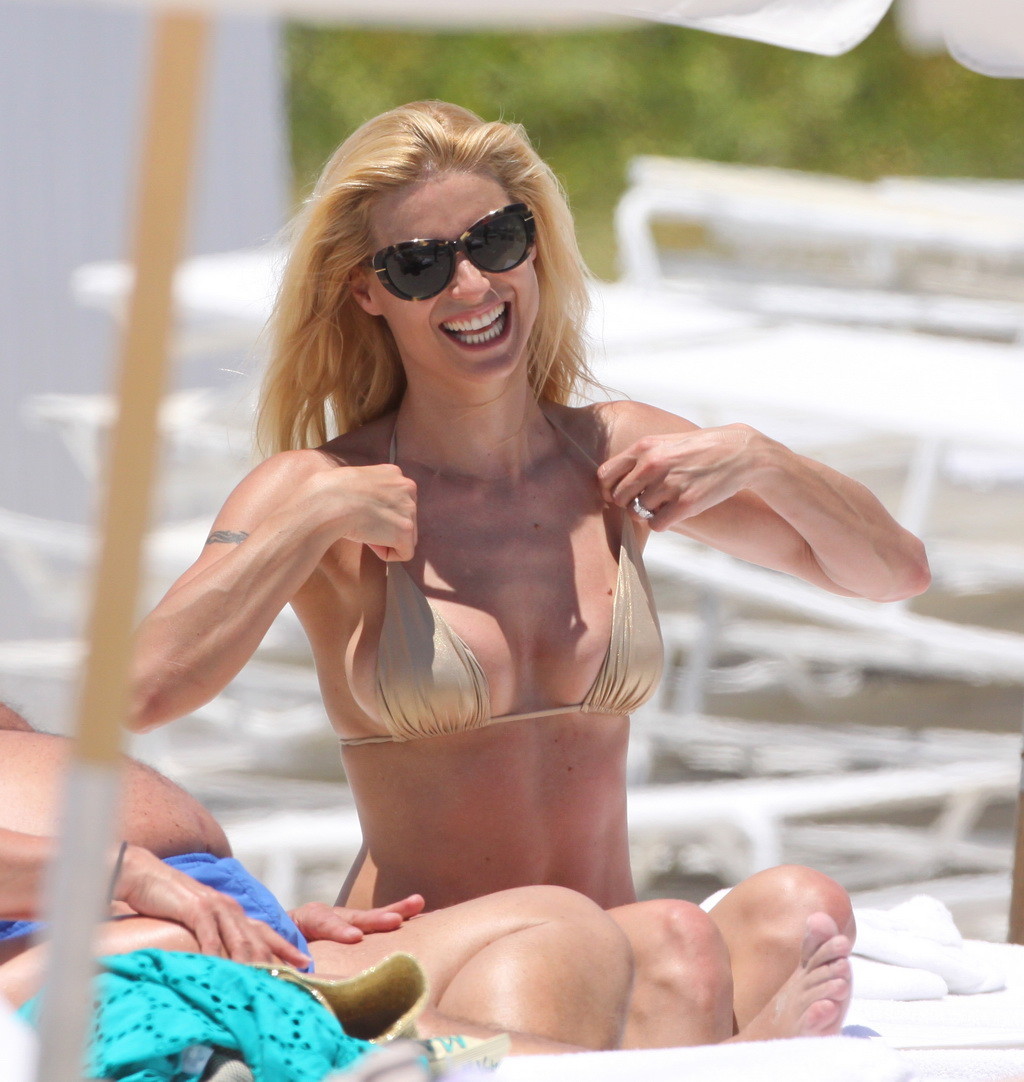 Michelle Hunziker wearing a gold bikini on the beach in Miami #75264942