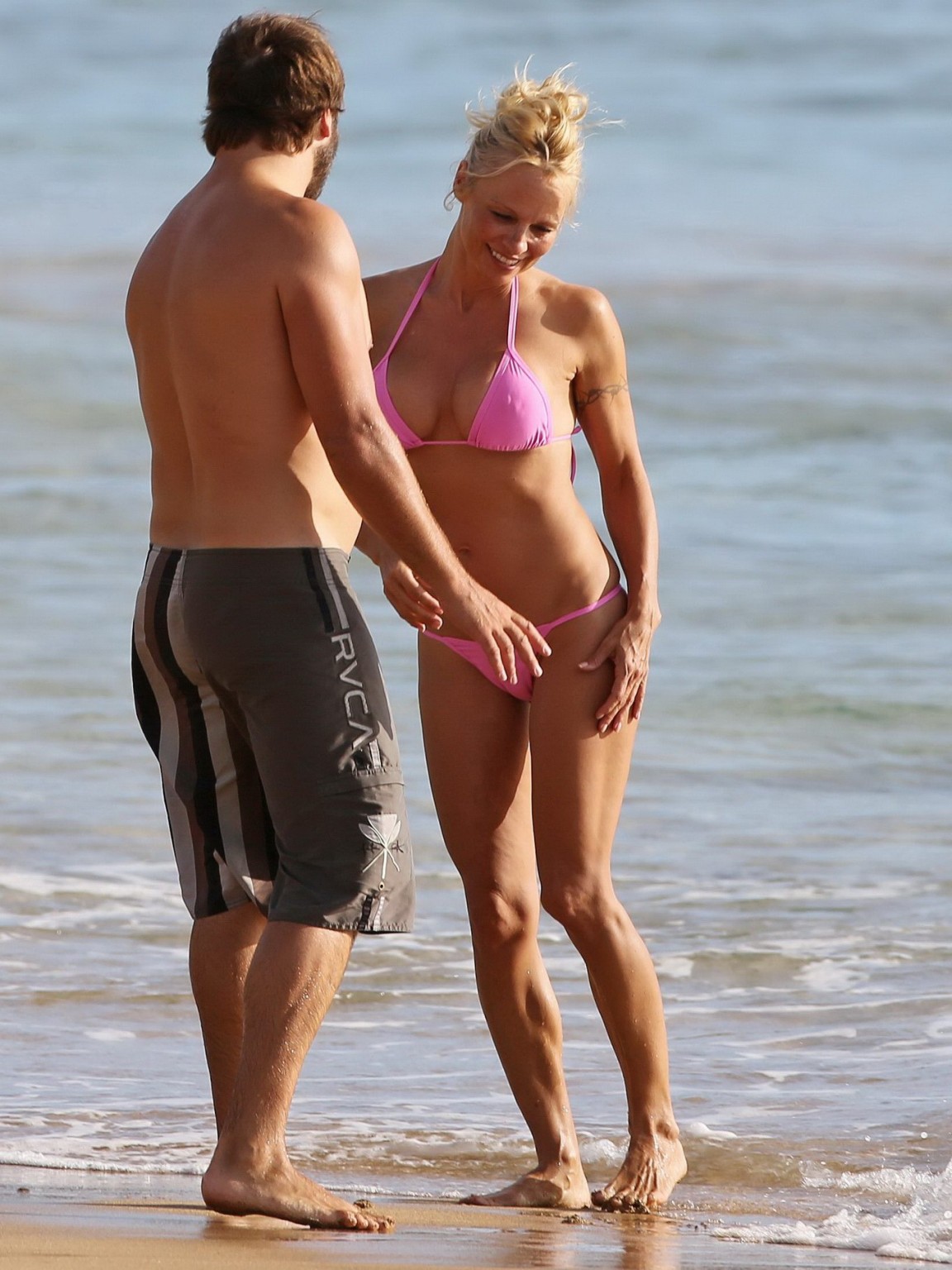 Pamela anderson montre ses seins en portant un bikini transparent mouillé sur une plage. 
 #75222201