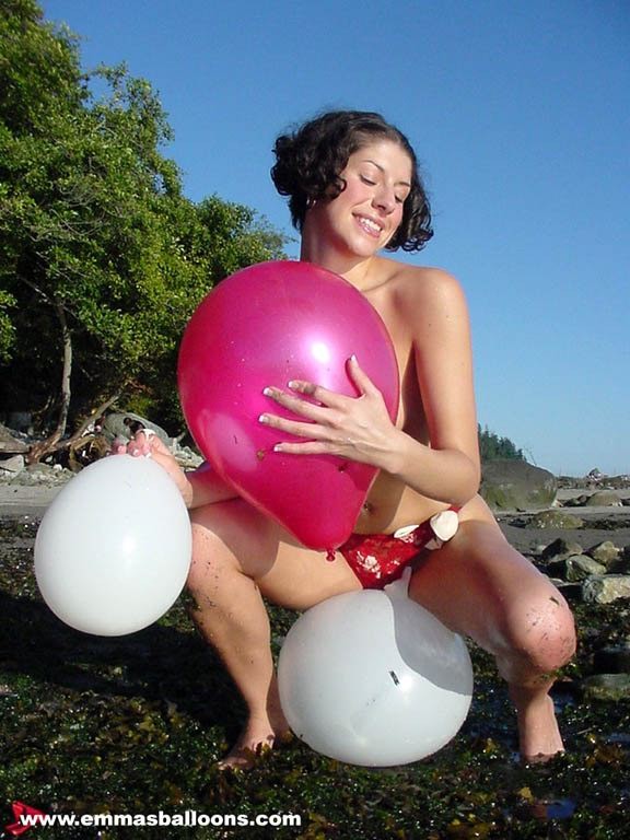 amateur brunette girl playing with balloons on the beach #72317196