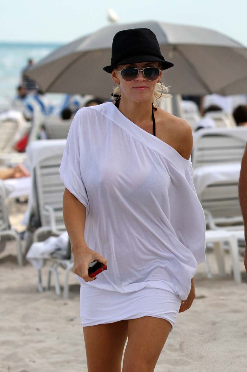 Jenny McCarthy exposing her sexy body and huge boobs in black bikini on beach #75313443