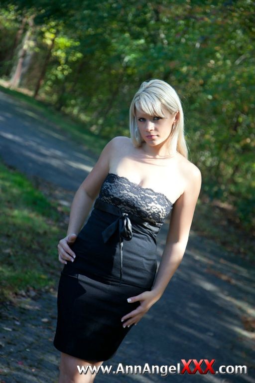 Sexy blonde outdoors in her black dress #72613068