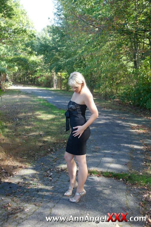 Sexy blonde outdoors in her black dress #72613076