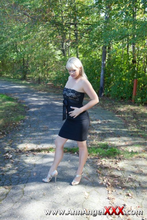 Sexy blonde outdoors in her black dress #72613139