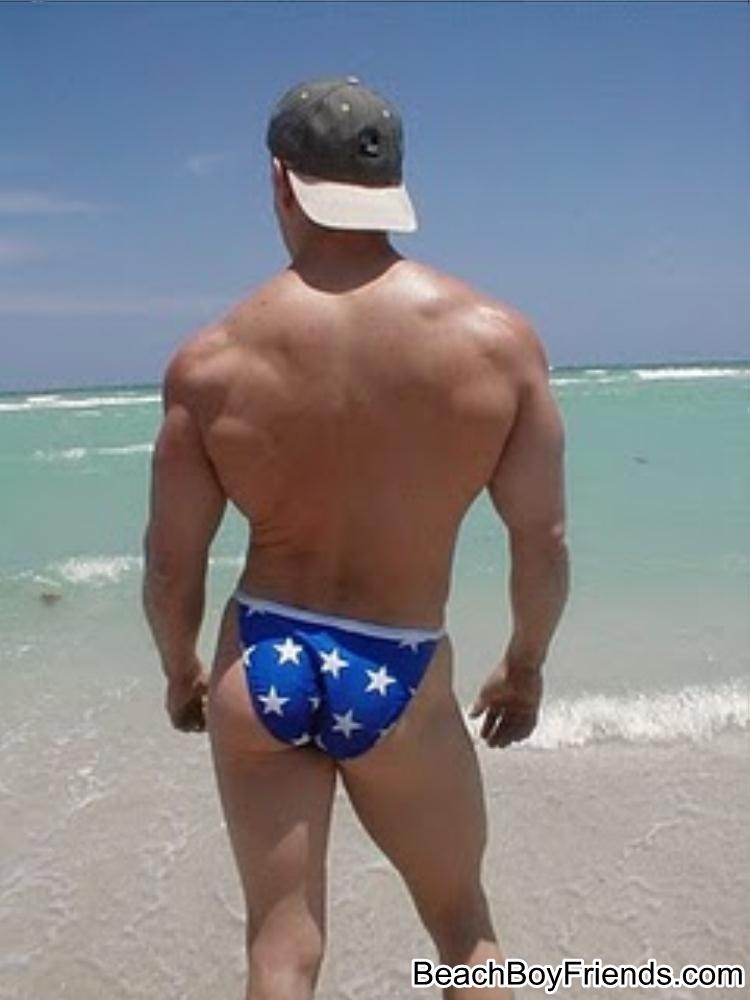 Big muscled dudes are wearing tight trunks at the beach #76945128