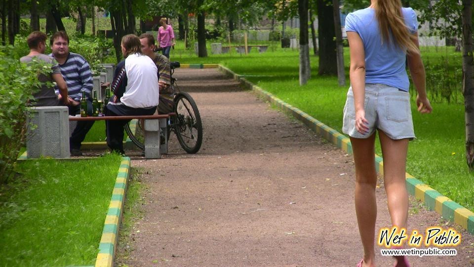 Gal with long ponytail spreading and wetting herself on a garden bench #73238531