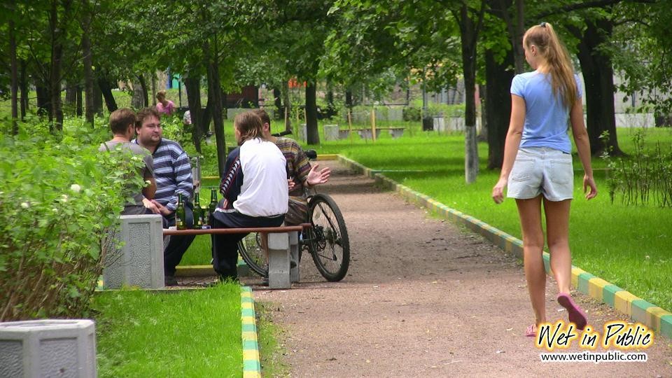 Gal with long ponytail spreading and wetting herself on a garden bench #73238543