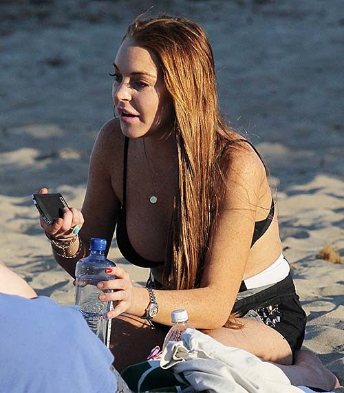 Lindsay Lohan exposing huge boobs in bikini top on beach #75254832