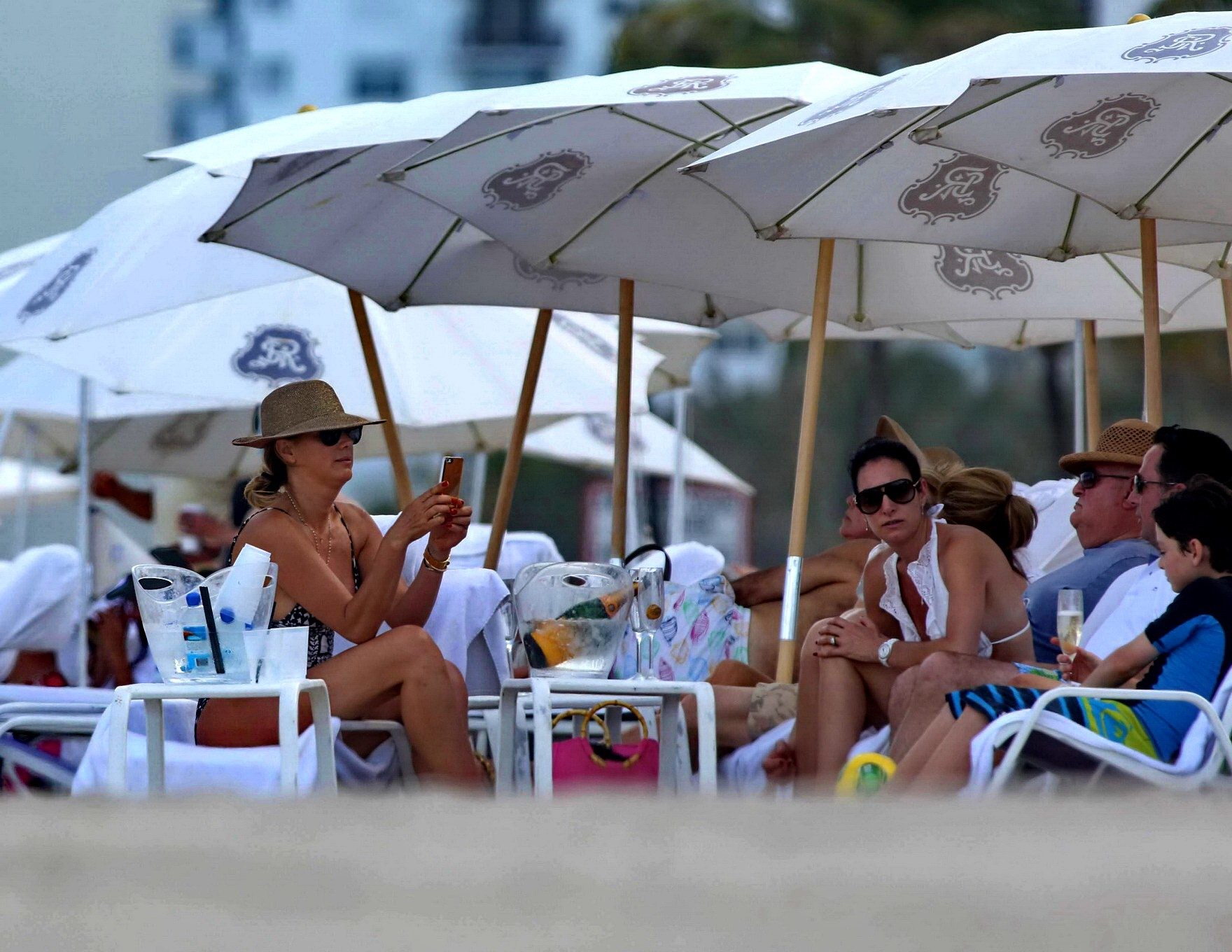 Daisy Fuentes showing ass and sideboob wearing a monochrome bikini on a beach in #75196513