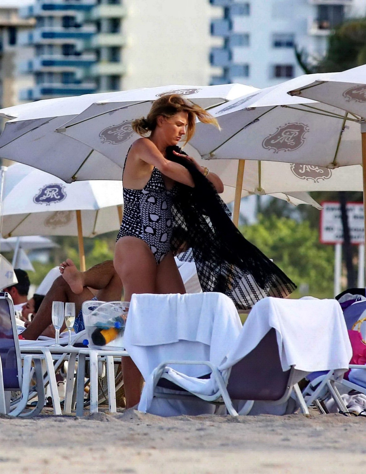 Daisy Fuentes showing ass and sideboob wearing a monochrome bikini on a beach in #75196518