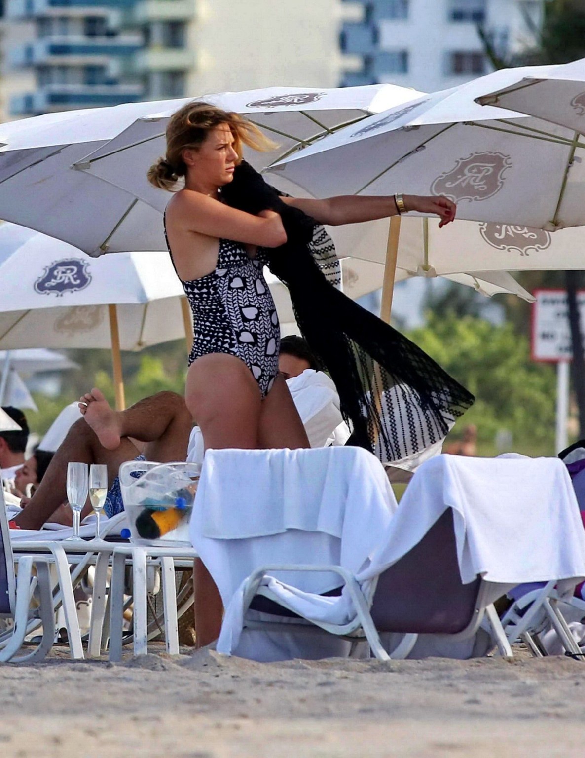 Daisy Fuentes showing ass and sideboob wearing a monochrome bikini on a beach in #75196523