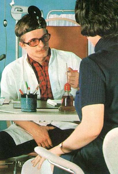 Seventies doctor inspecting two retro ladies #77326731