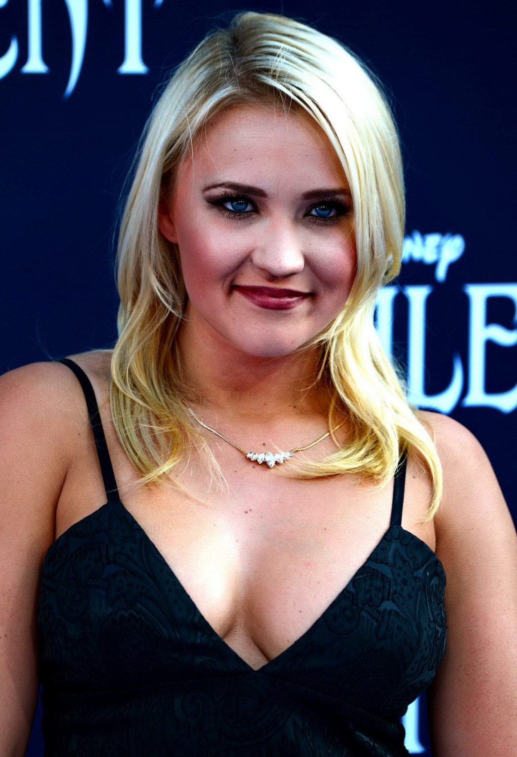 Busty Emily Osment wearing a low cut black dress at the Maleficent premiere in H #75195304