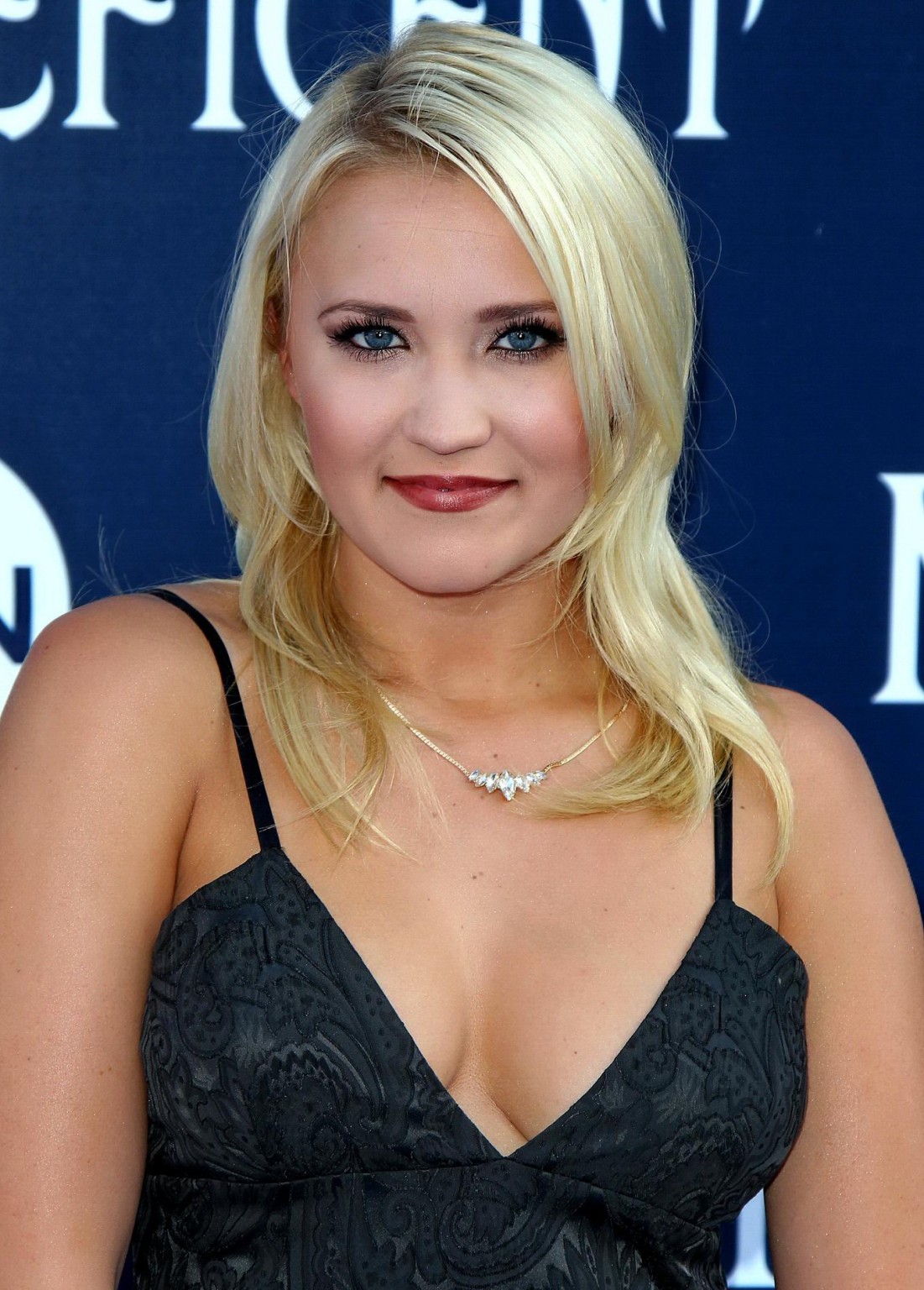 Busty Emily Osment wearing a low cut black dress at the Maleficent premiere in H #75195307