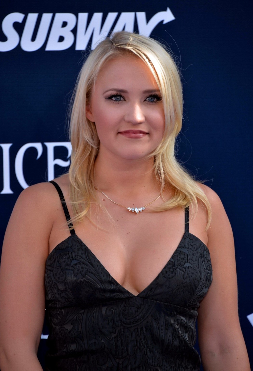 Busty Emily Osment wearing a low cut black dress at the Maleficent premiere in H #75195311