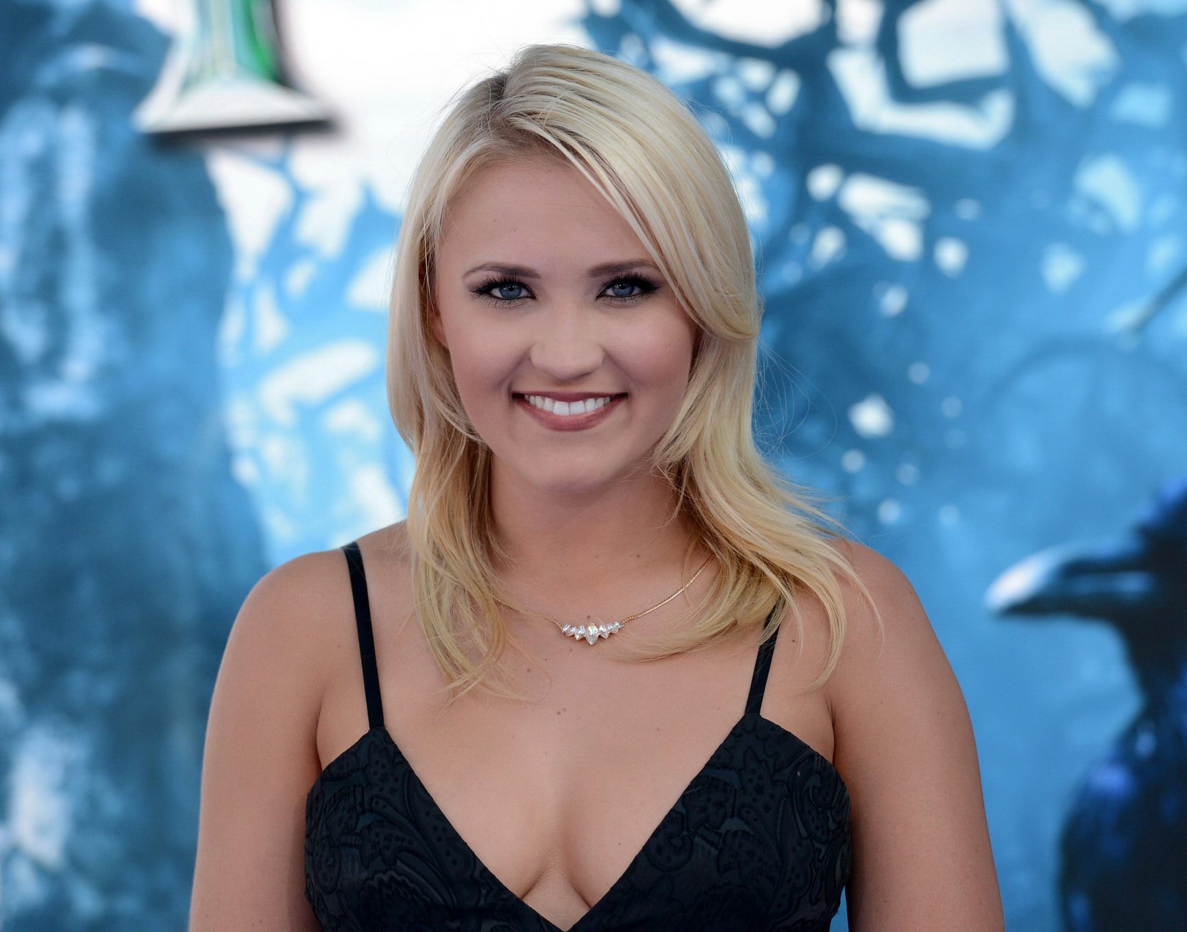 Busty Emily Osment wearing a low cut black dress at the Maleficent premiere in H #75195335