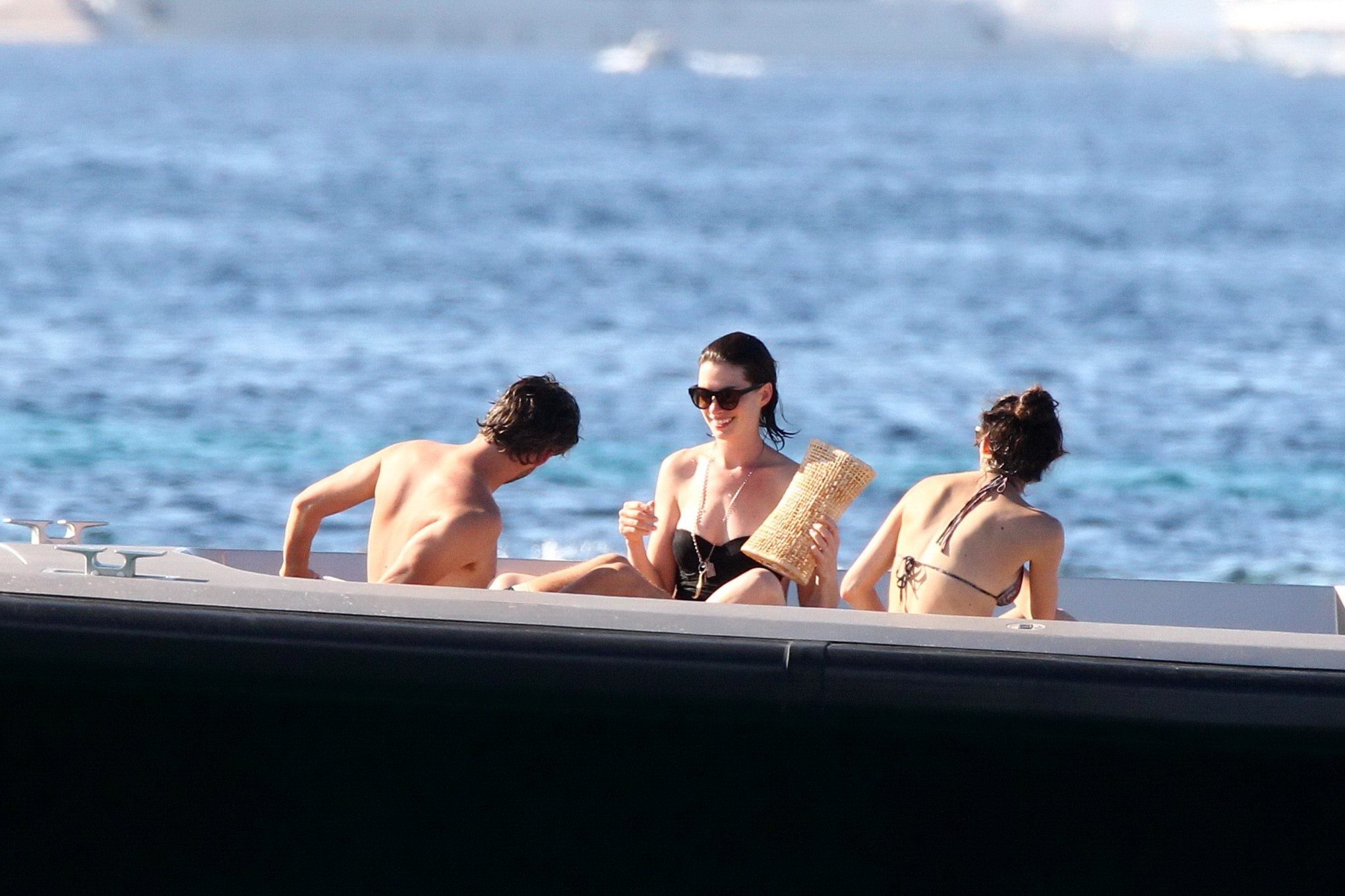 Anne Hathaway busty wearing a strapless black swimsuit #75155168