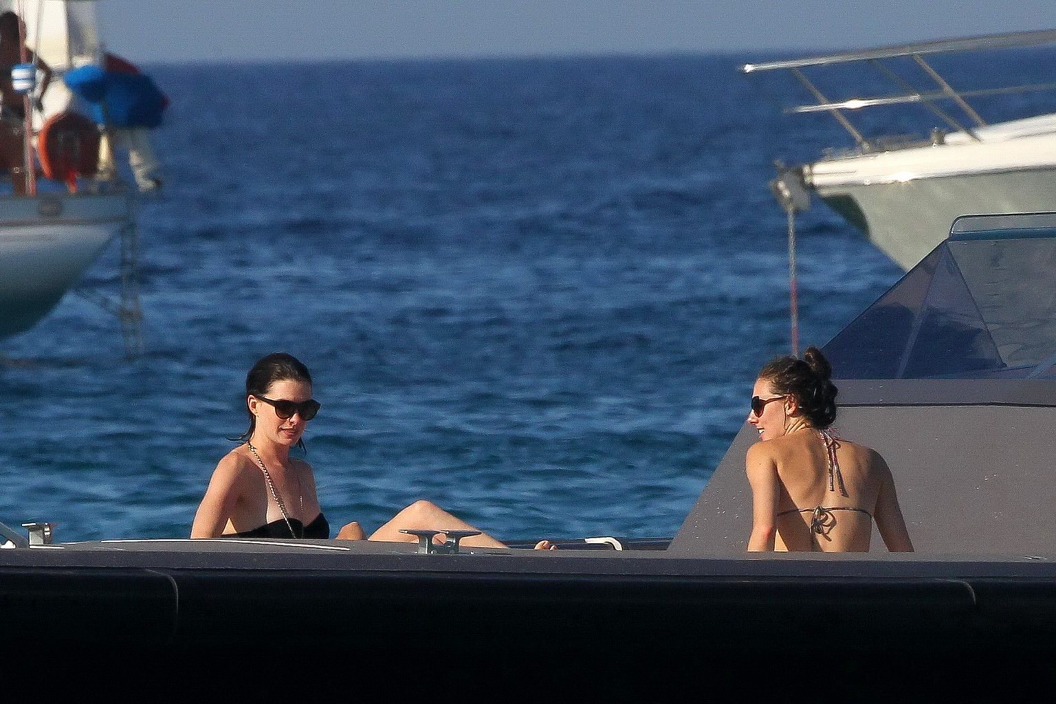 Anne Hathaway busty wearing a strapless black swimsuit #75155174