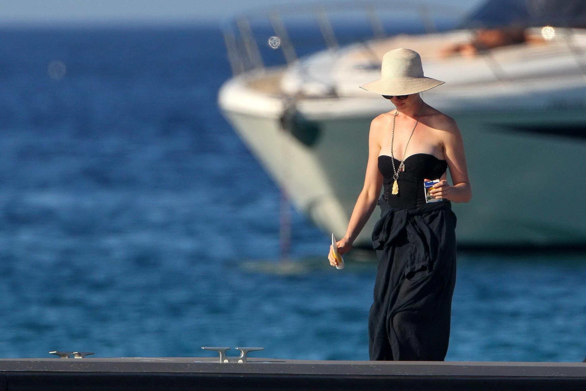 Anne Hathaway busty wearing a strapless black swimsuit #75155206