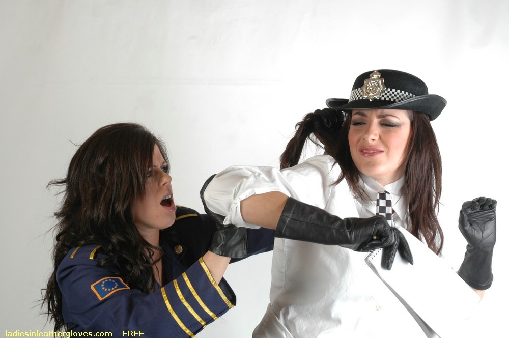 Two gils in uniforms and leather gloves having a fight #75733155