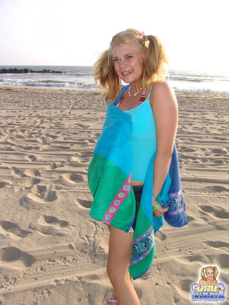 An outdoor blonde teenie in bikini on the beach #79017515