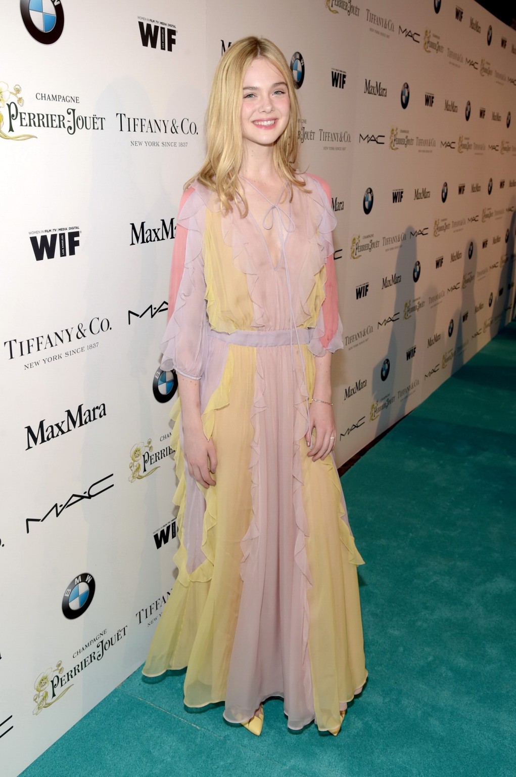 Elle Fanning braless wearing a sexy dress at the 8th Annual Women in Film PreOsc