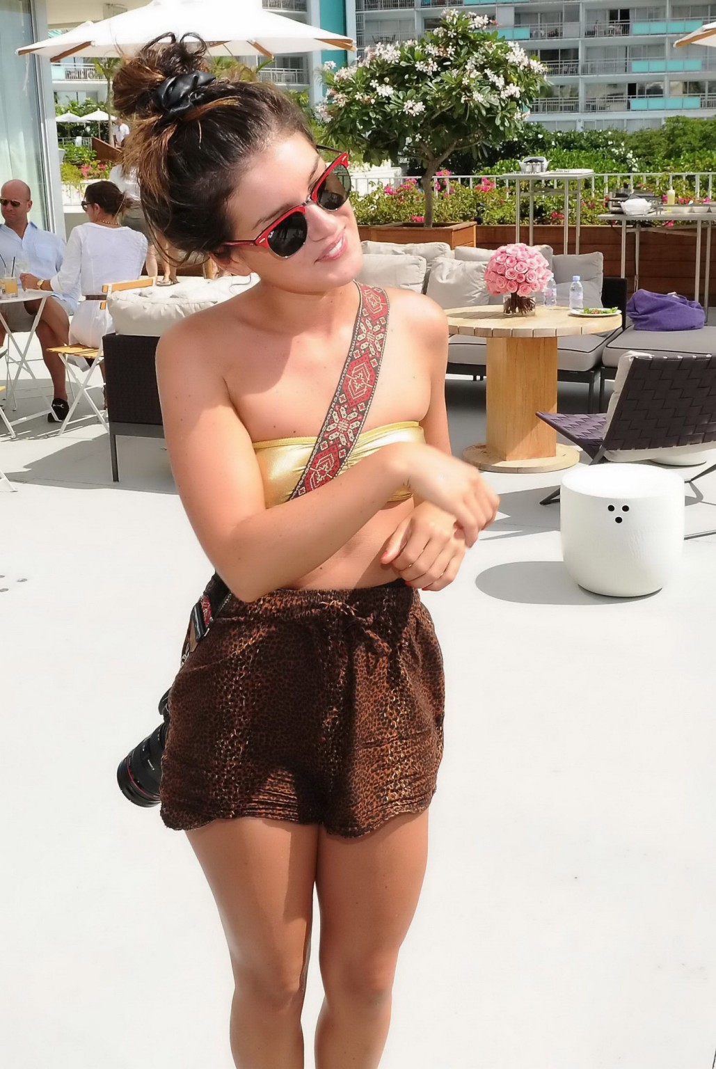 Shenae Grimes wearing golden bikini top and shorts at the Waikiki Edition Openin #75219785
