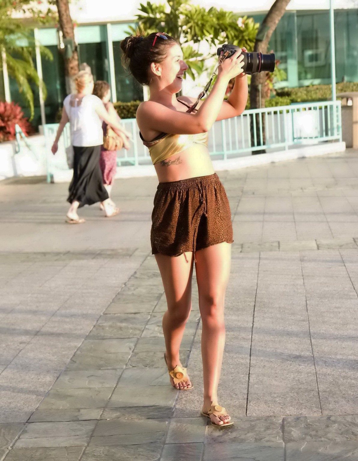 Shenae Grimes wearing golden bikini top and shorts at the Waikiki Edition Openin #75219787