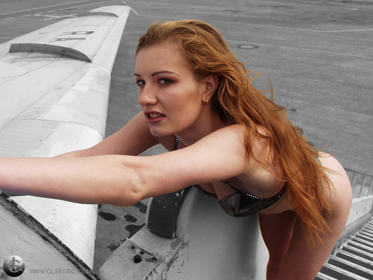 Flexible redhead stewardess doing the splits #78793107