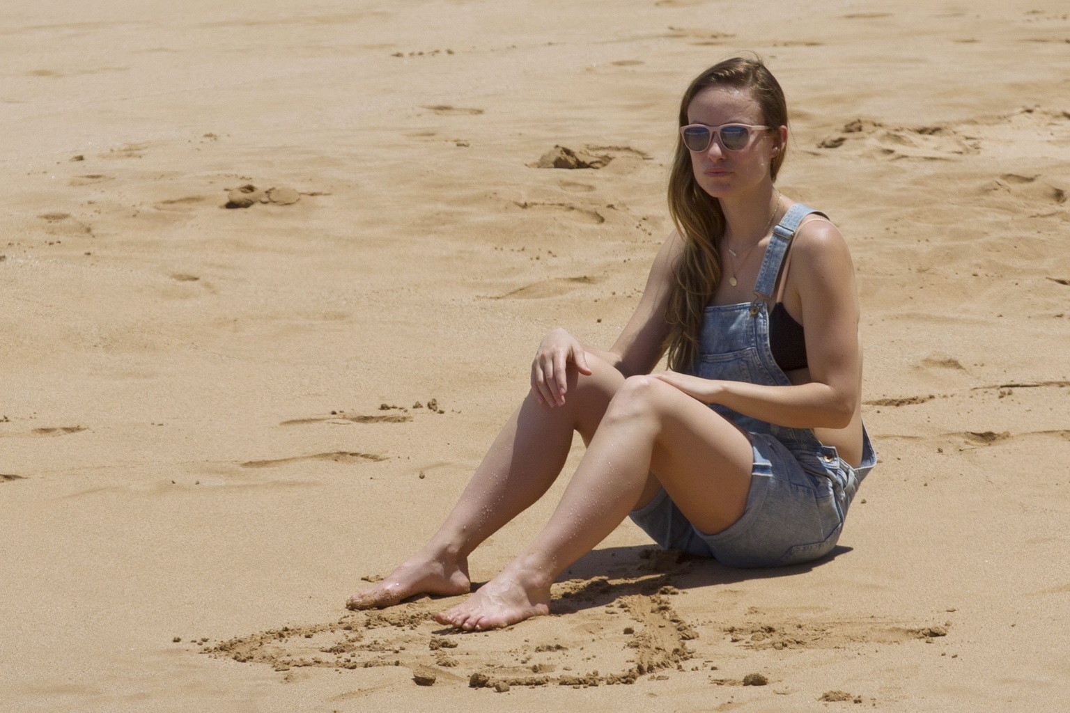 Olivia Wilde tetona en bikini negro y mono en una playa
 #75143647