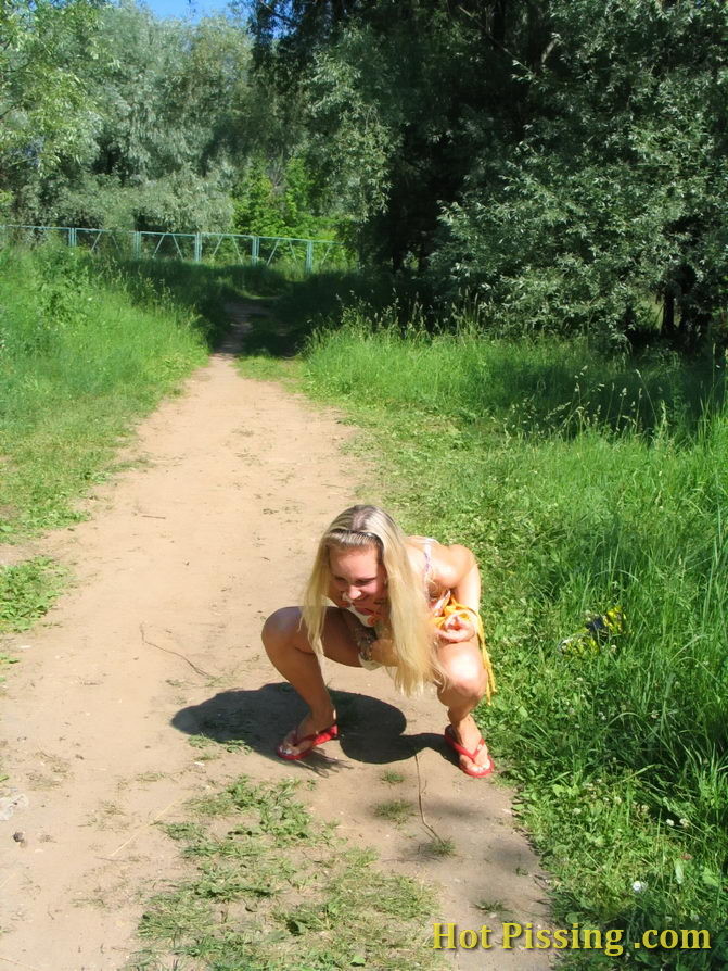 Blonde hottie with long hair takes pleasure in doing a pee on the road #76566425