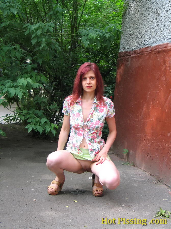 Hot redhead can not hold it in and relieves herself behind a building #76566122