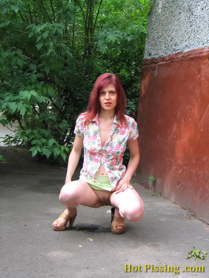 Hot redhead can not hold it in and relieves herself behind a building #76566135