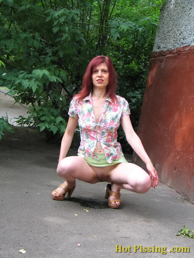 Hot redhead can not hold it in and relieves herself behind a building #76566162