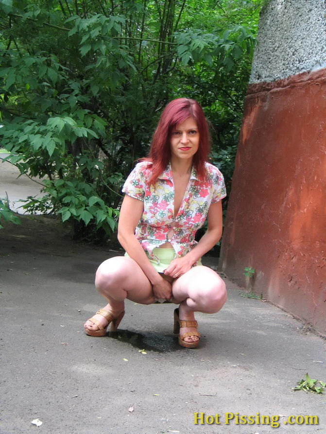 Hot redhead can not hold it in and relieves herself behind a building #76566190