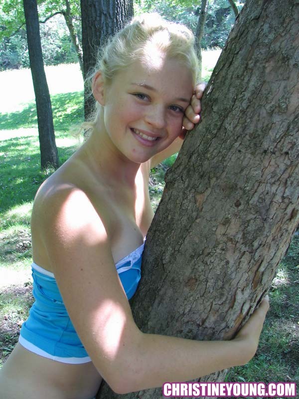 Pretty blonde teen girl Christine Young posing in a park #67769993