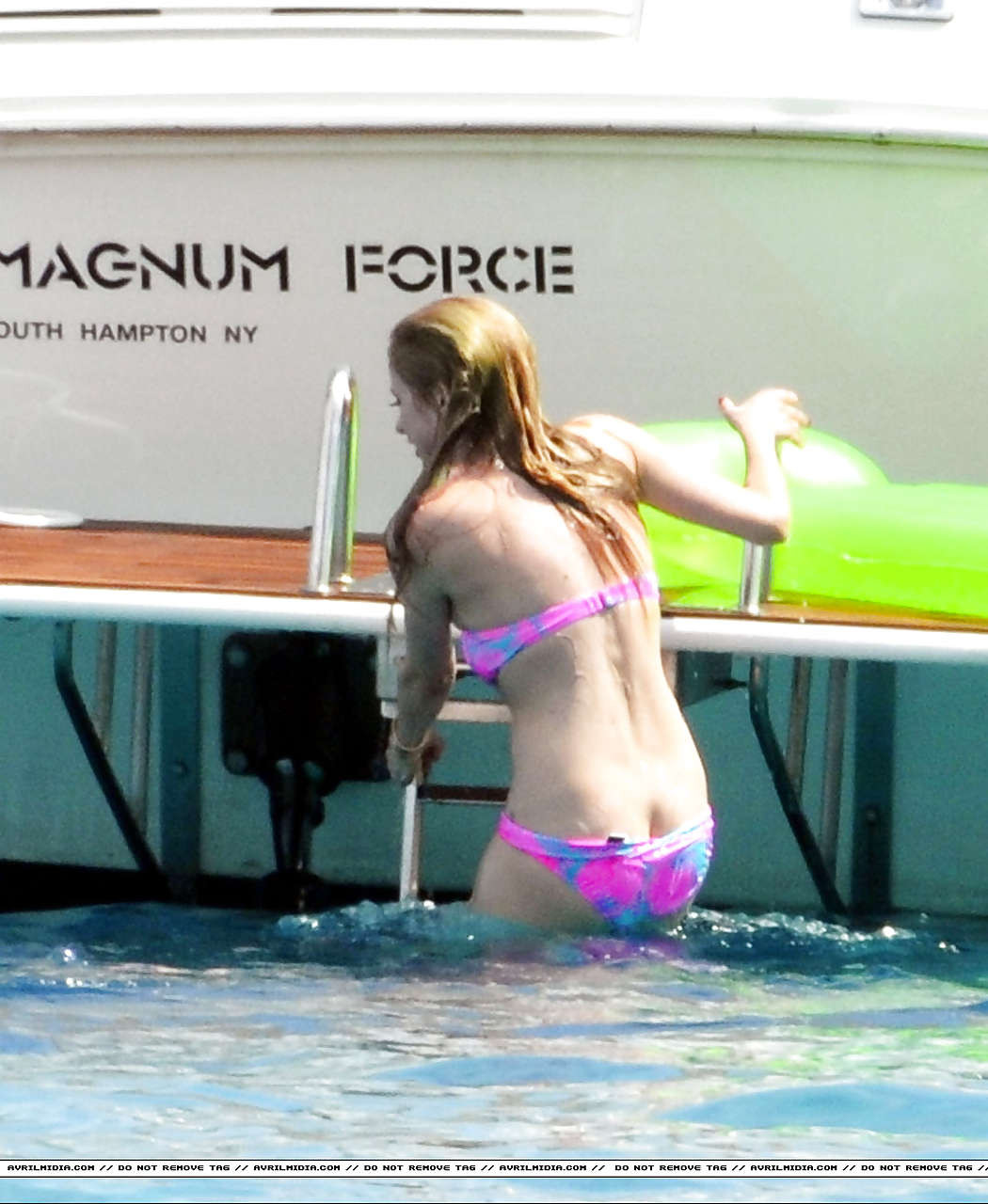 Avril Lavigne showing part of her ass and nipple slip in bikini on beach #75297351