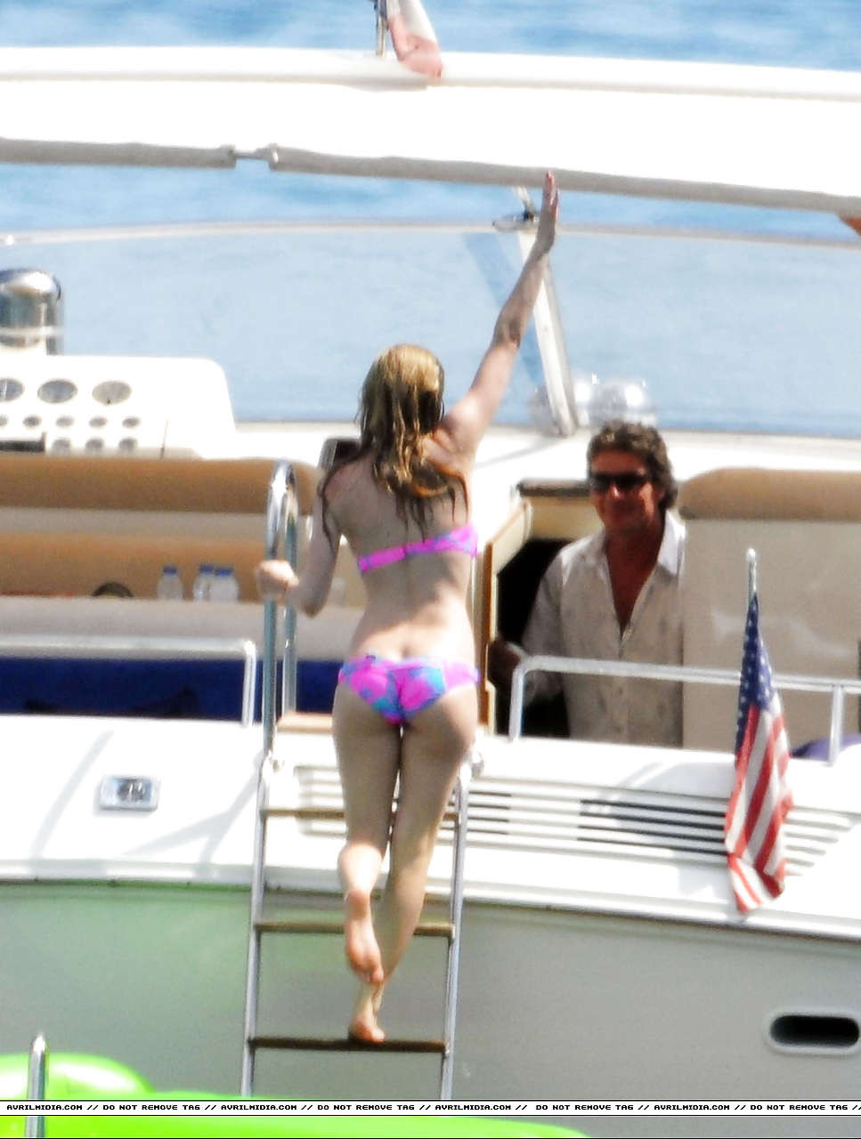 Avril Lavigne showing part of her ass and nipple slip in bikini on beach #75297370