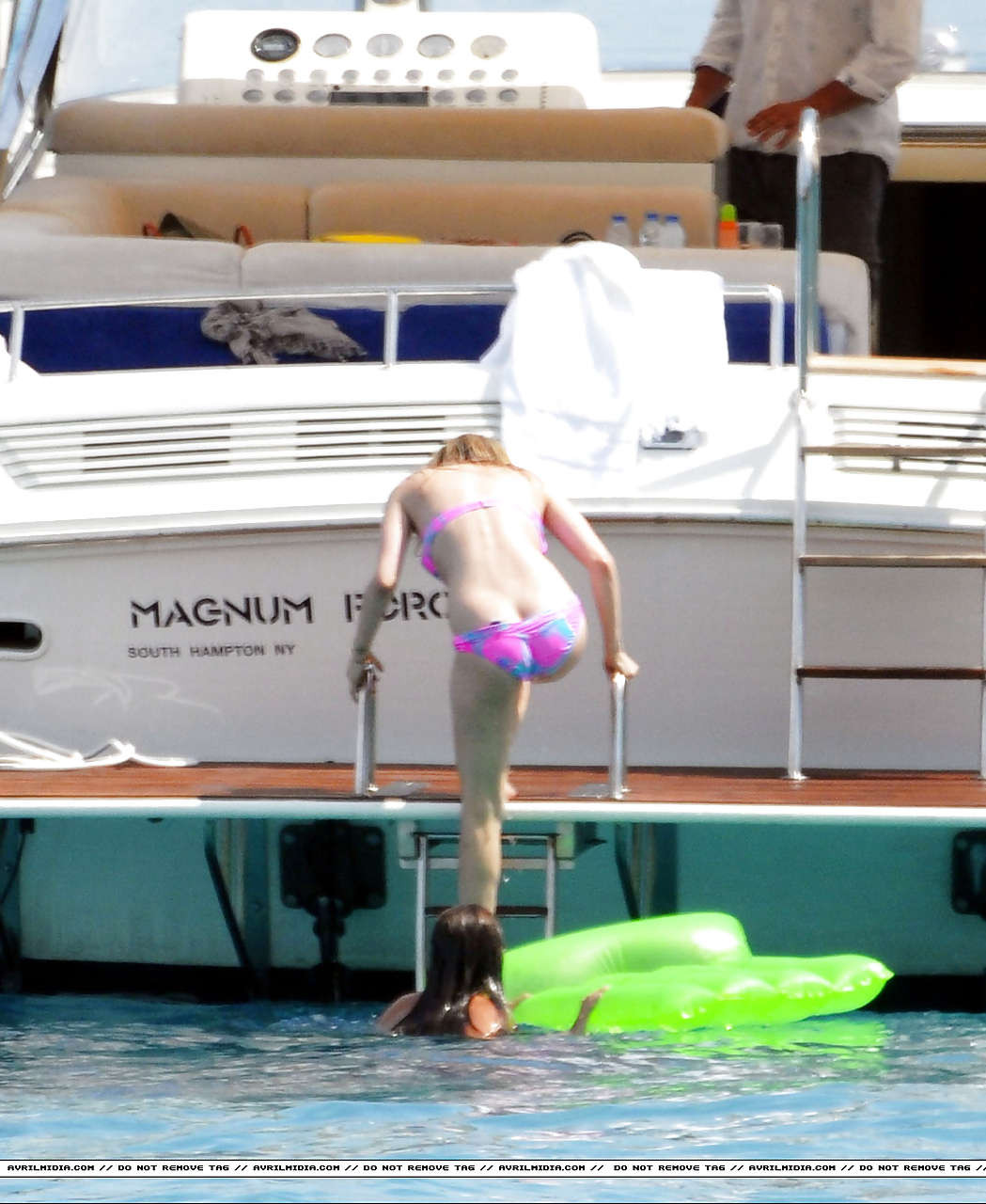Avril Lavigne showing part of her ass and nipple slip in bikini on beach #75297379