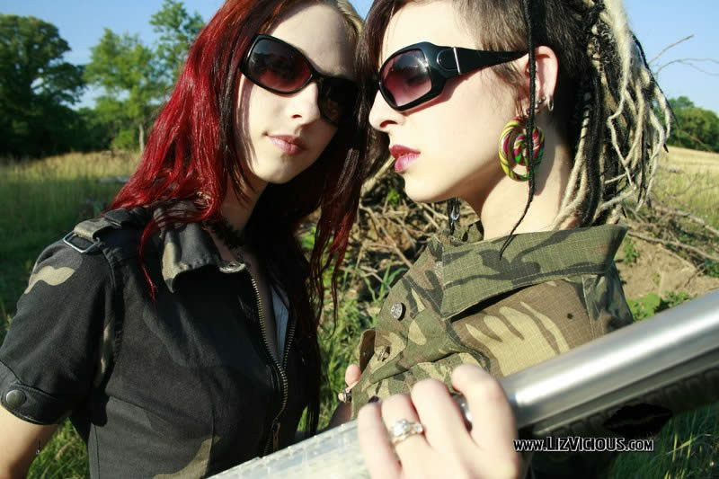 Two goth chicks play with guns and each other #76577428