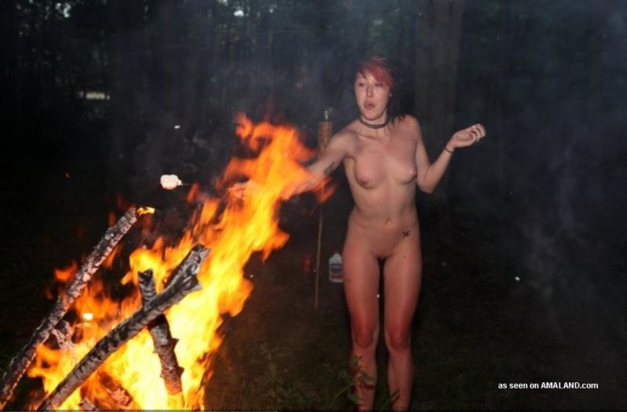 Wild naked girlfriend having fun posing at a bonfire #67615900