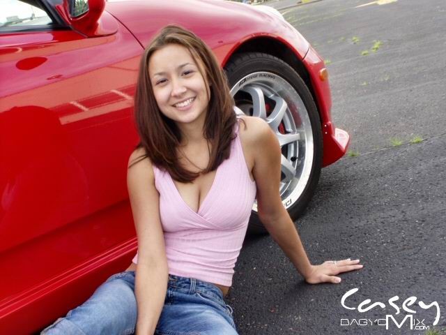 Asian teen posing outside with cars #70012379