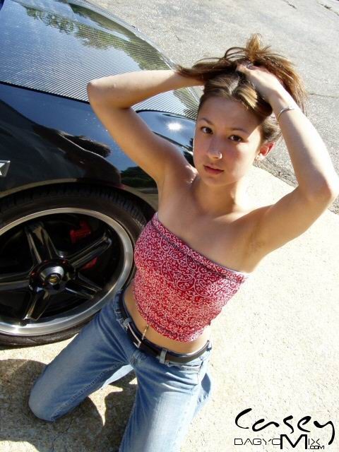 Asian teen posing outside with cars #70012432