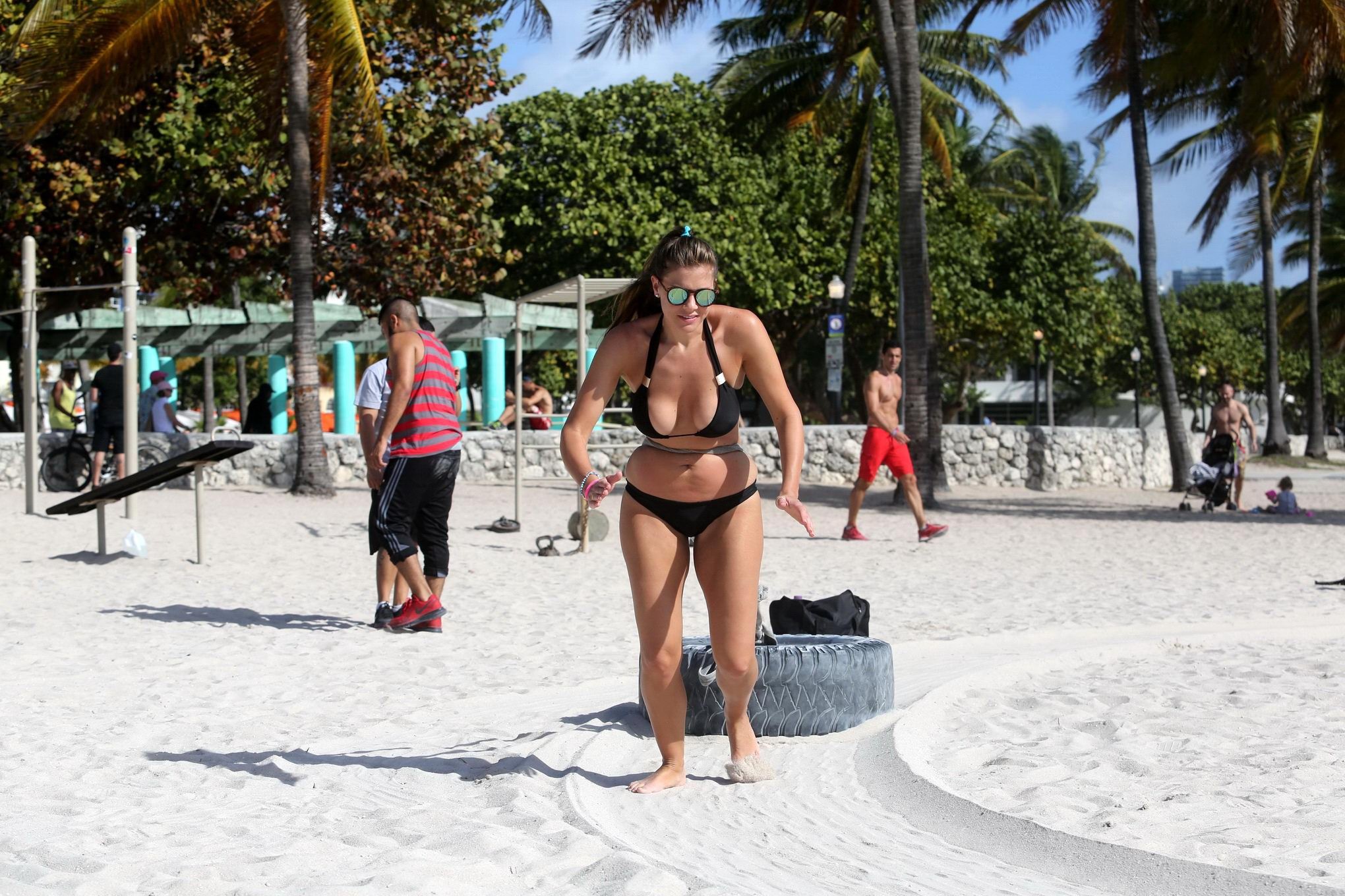 Busty Imogen Thomas works out wearing a skimpy black bikini on a beach in Miami #75170835