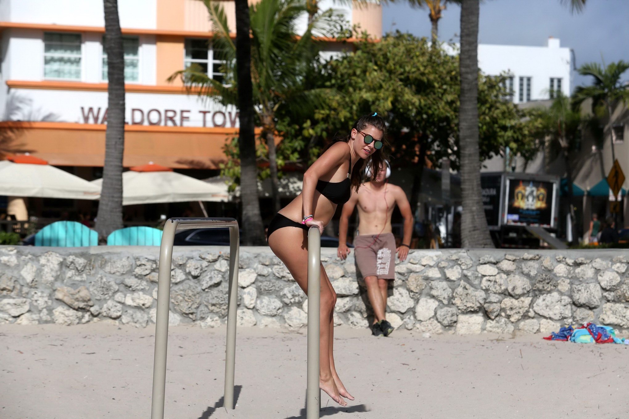 Busty Imogen Thomas works out wearing a skimpy black bikini on a beach in Miami #75170865