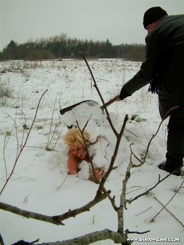 Esclava rubia amordazada y enterrada desnuda en la fría nieve
 #72213483