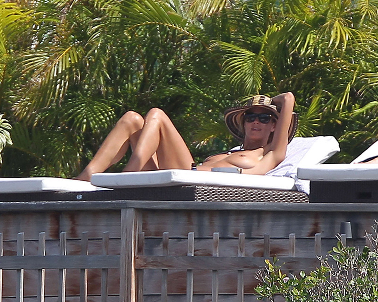 Heidi Klum tanning topless poolside in St Barts #75176315