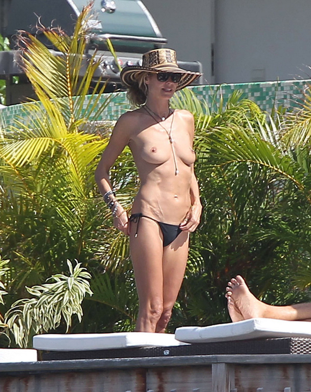 Heidi Klum tanning topless poolside in St Barts #75176335