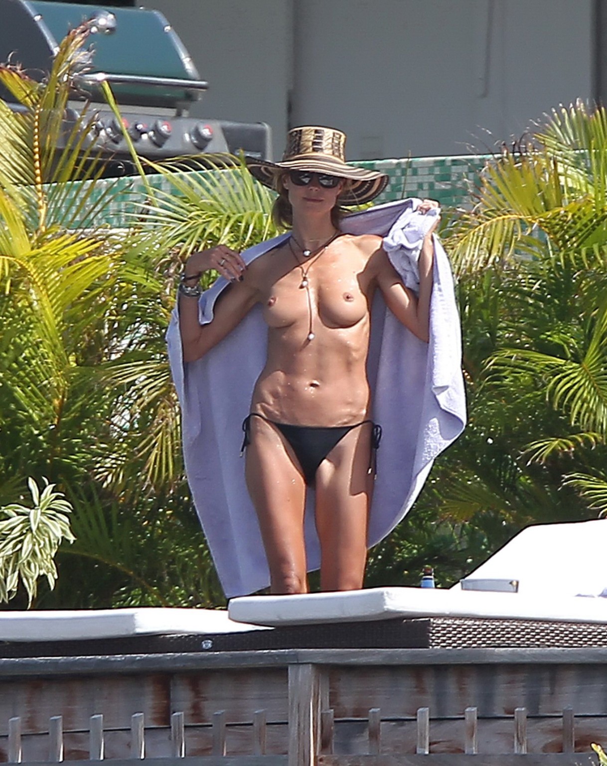 Heidi Klum tanning topless poolside in St Barts #75176348