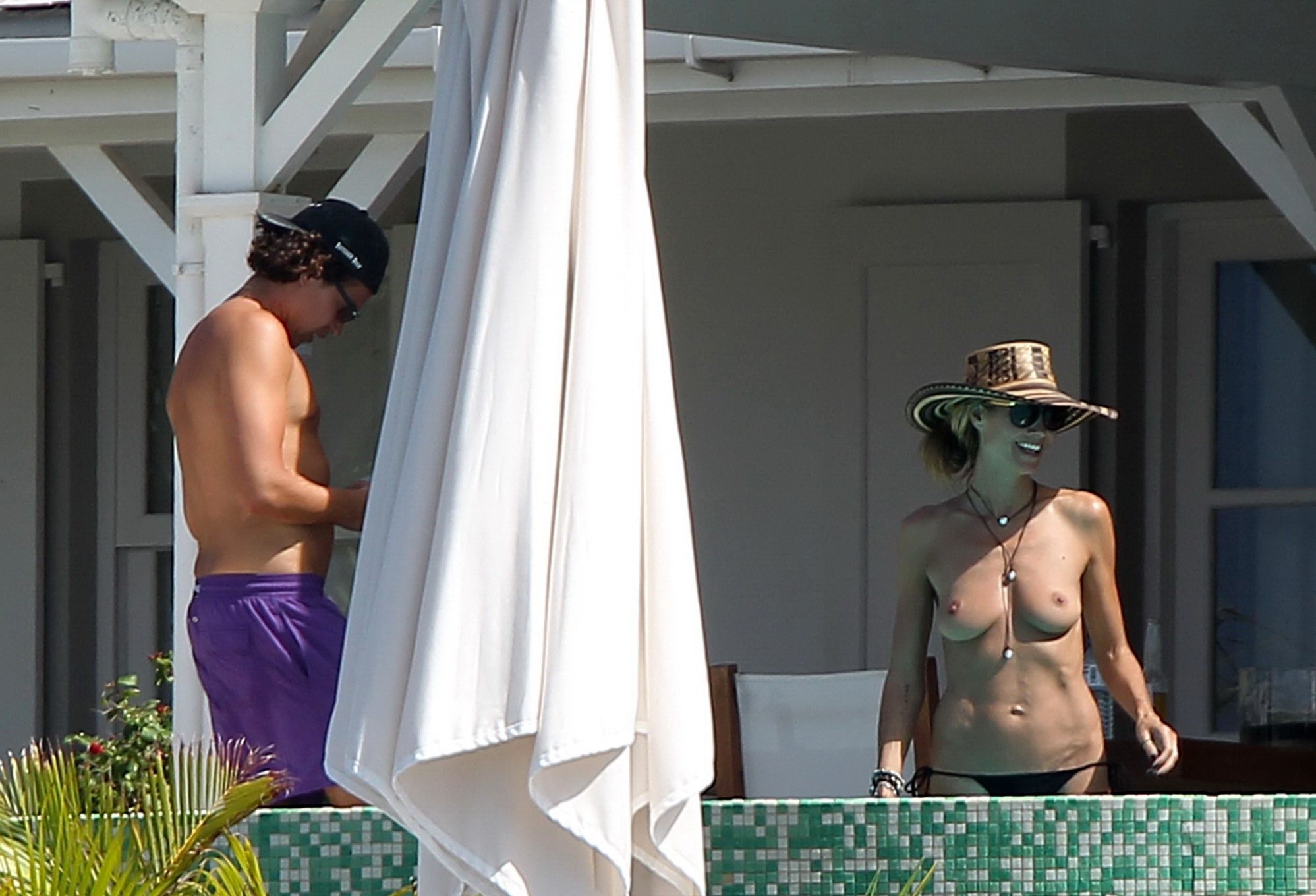 Heidi Klum tanning topless poolside in St Barts #75176356
